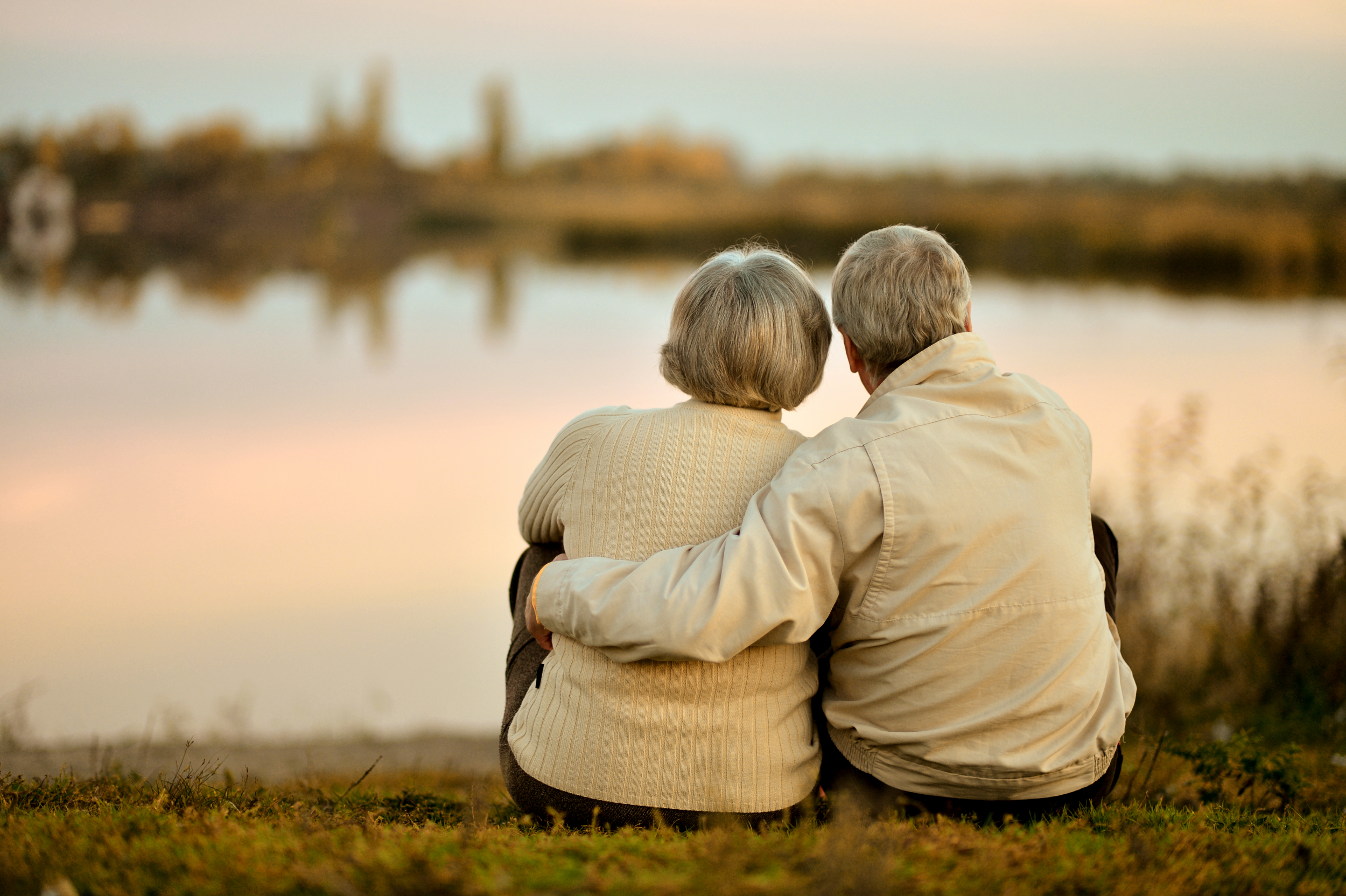 Elderly couple sitting together in a park